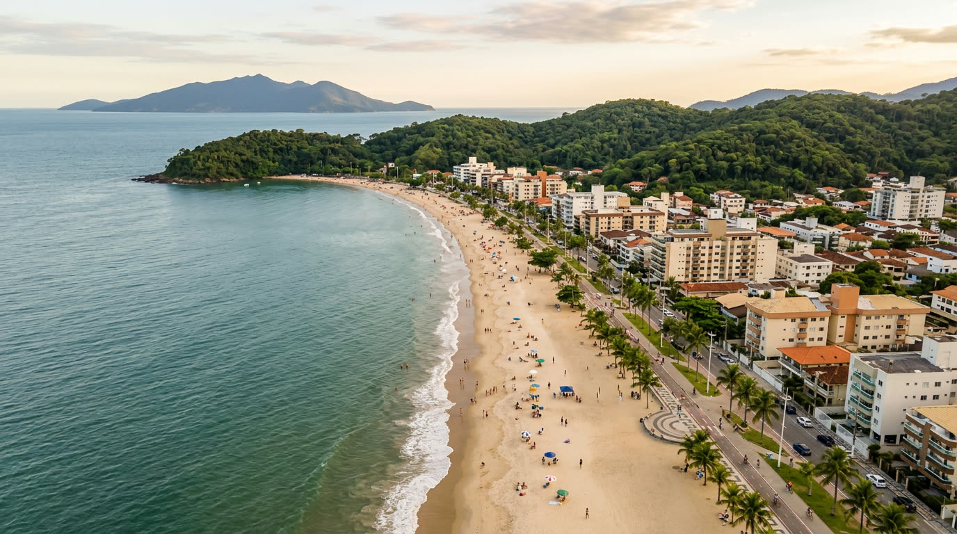 Vista aérea de praia urbana com morros de Mata Atlântica no litoral norte de São Paulo (imagem ilustrativa)